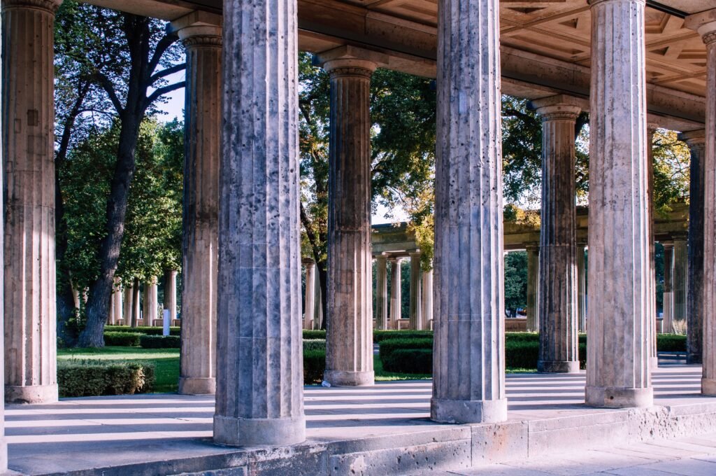 Classical columns in an outdoor setting, evoking ancient architecture.